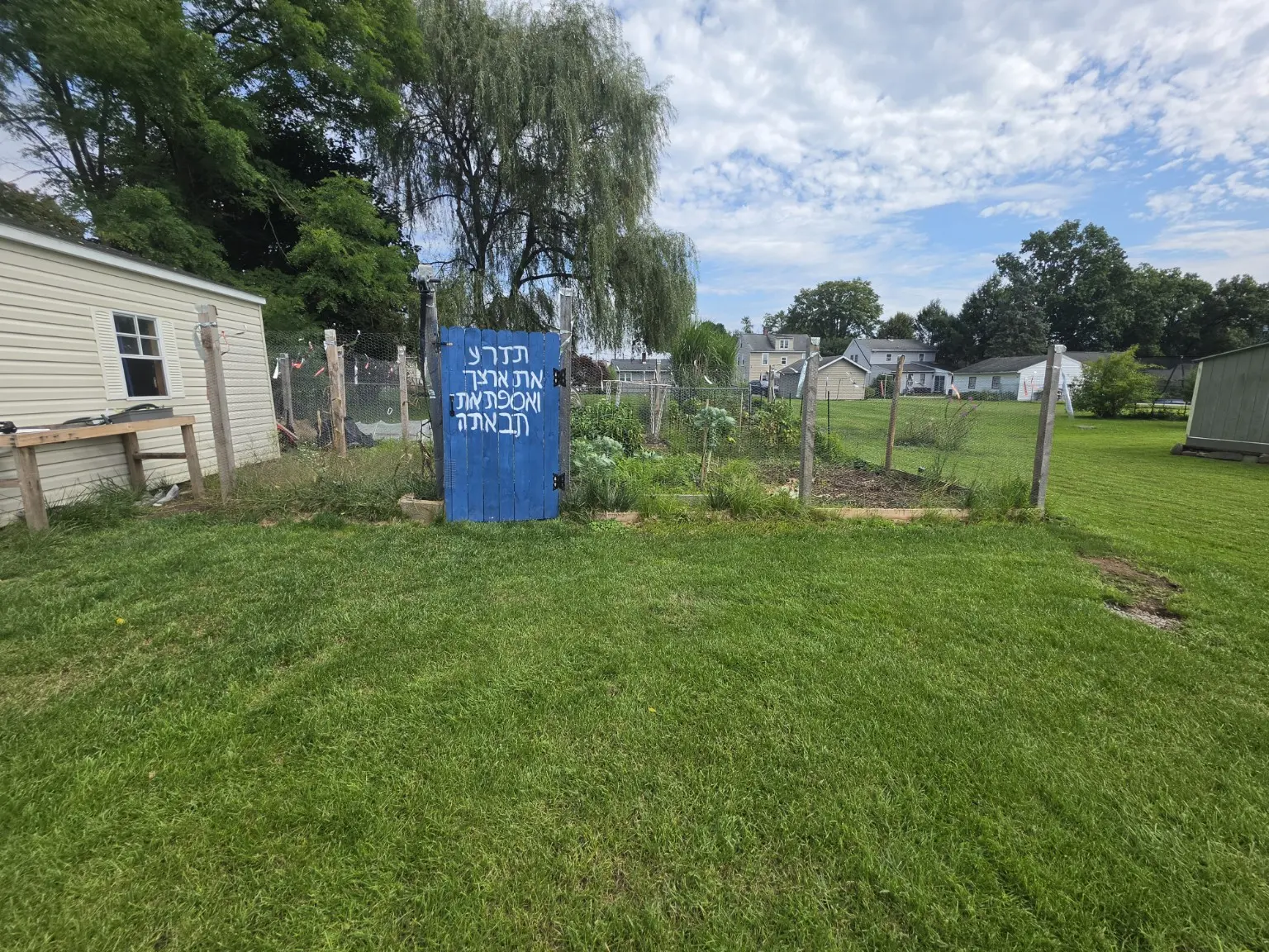 Blue gate at the entrance to the Bear Produce garden